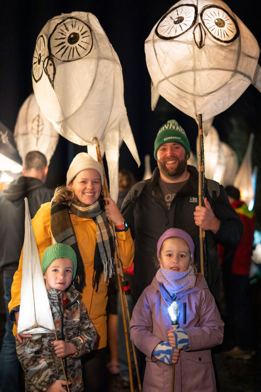 a family posing with owl lanterns at the mayo dark sky festival